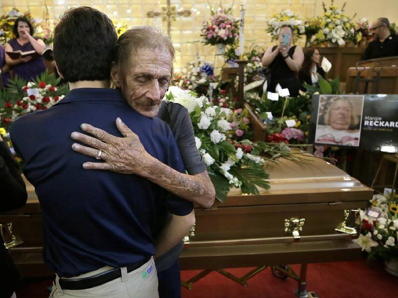 Strangers offered support to Antonio Basco (R) at the funeral for El Paso victim Margie Reckard.