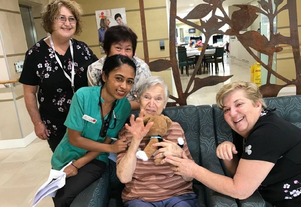 SMALL WONDERS - Bolton Clarke Cabrini staff with resident Gertie (seated, centre) cuddling Tiny.