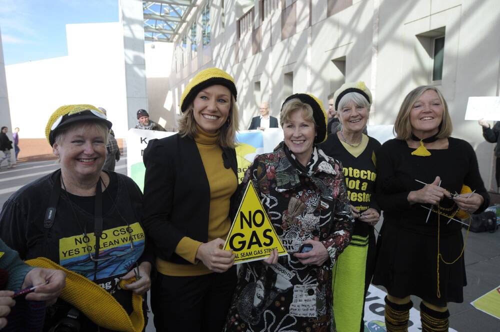 EVERGREEN – Christine Milne (centre) with former Greens senator Larissa Waters  (second from left) pose in beanies before  a Lock the Gate  protest in Canberra.