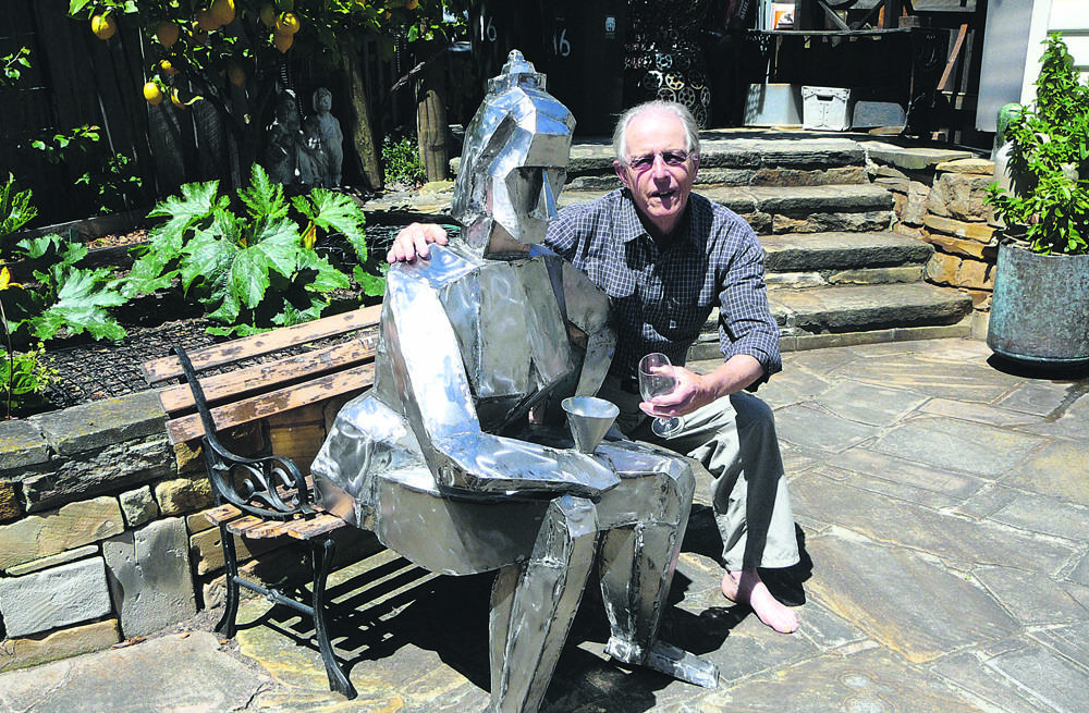HERE’S CHEERS – Artist Richard Whitaker with one of his stunning sculptures.