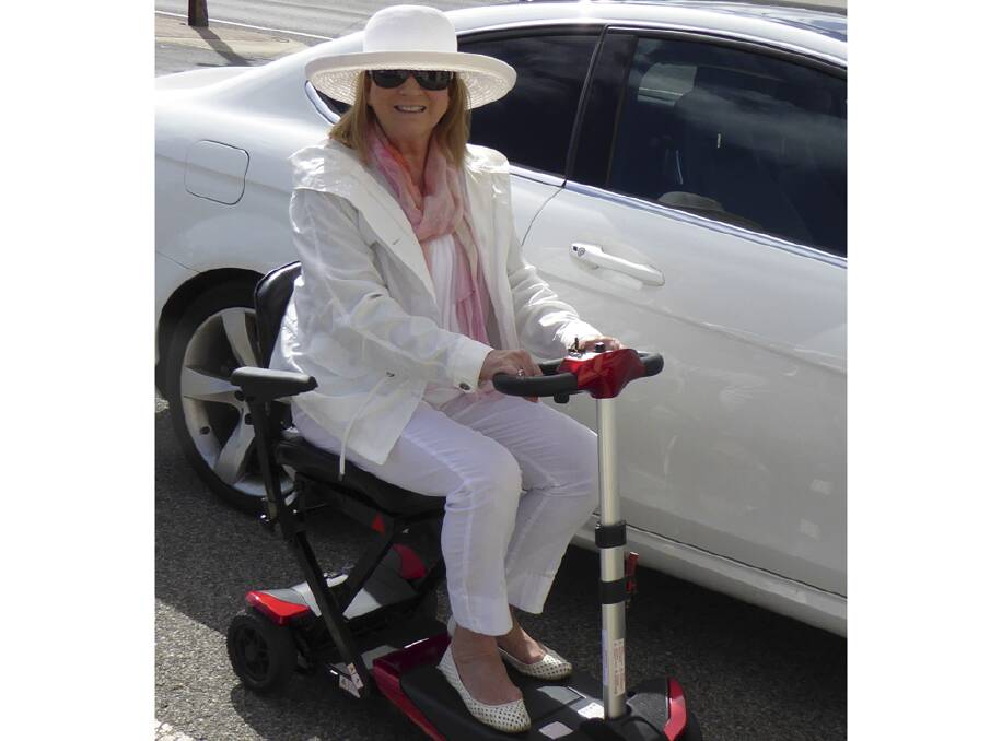 NIFTY MOVER - a happy traveller on her lightweight Solax Travel Mobility Scooter.