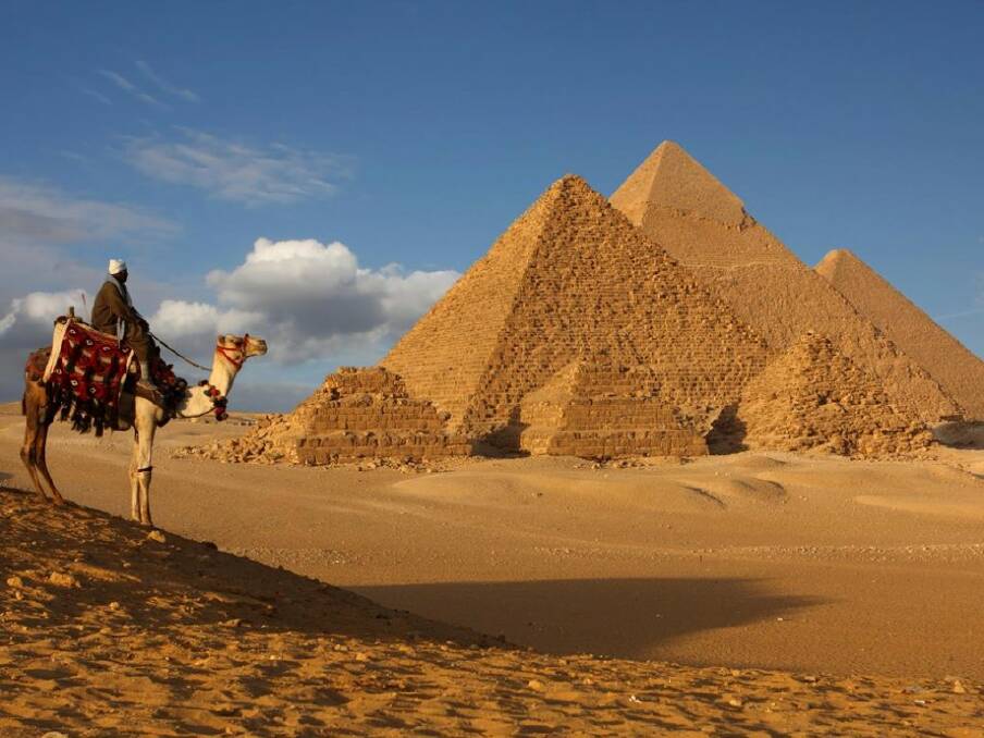 Stand before the Pyramid of Giza.