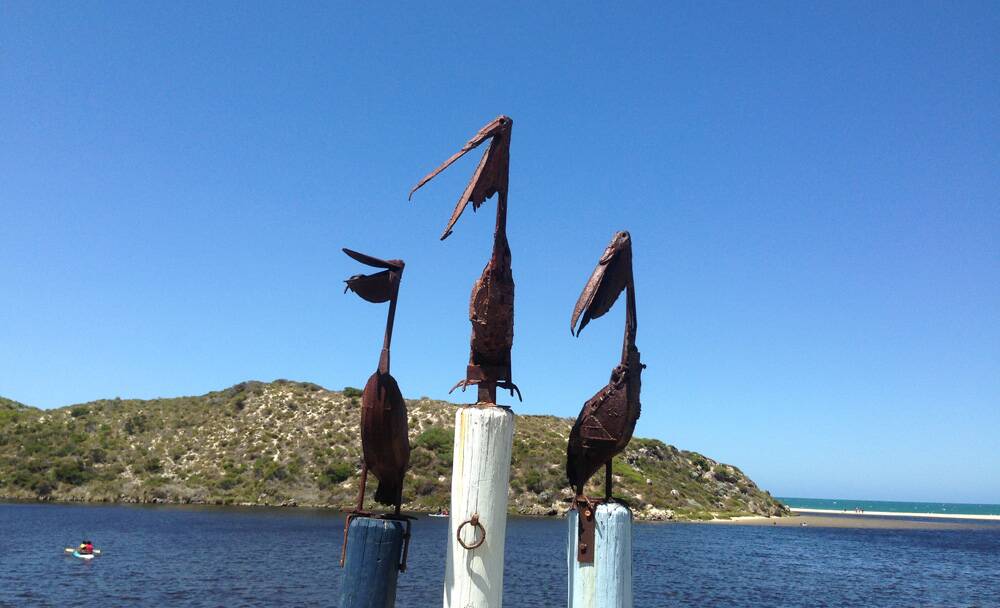 WHERE RIVER MEETS SEA – Pelican  statues always draw attention.