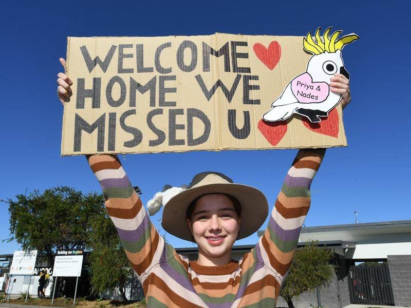 Supporter Isabelle Kelleher welcomes home the Nadesalingam family at Thangool Airport near Biloela.
