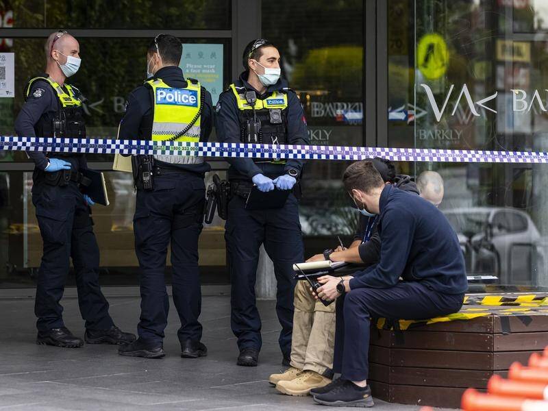 A man is in custody after two men were stabbed at a Melbourne shopping centre.