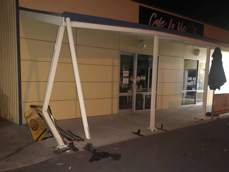 An alleged drunk driver was spotted speeding off after a car doing burnouts collected a cafe awning.