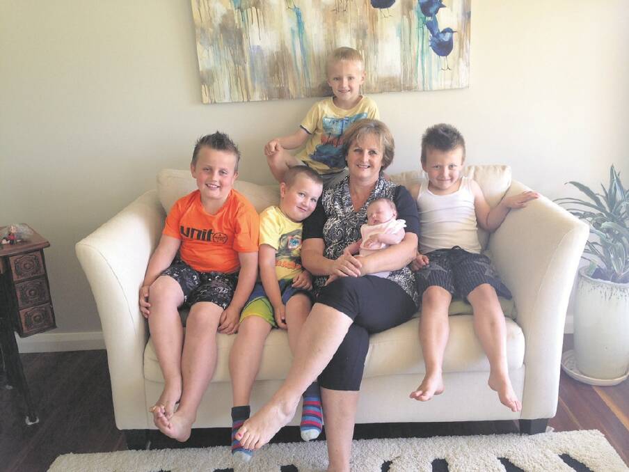 PLEASURE – Lyne Hirsch, holding granddaughter Layla, with her grandsons, from left, Jye, Wilson, Tannen and Blair.