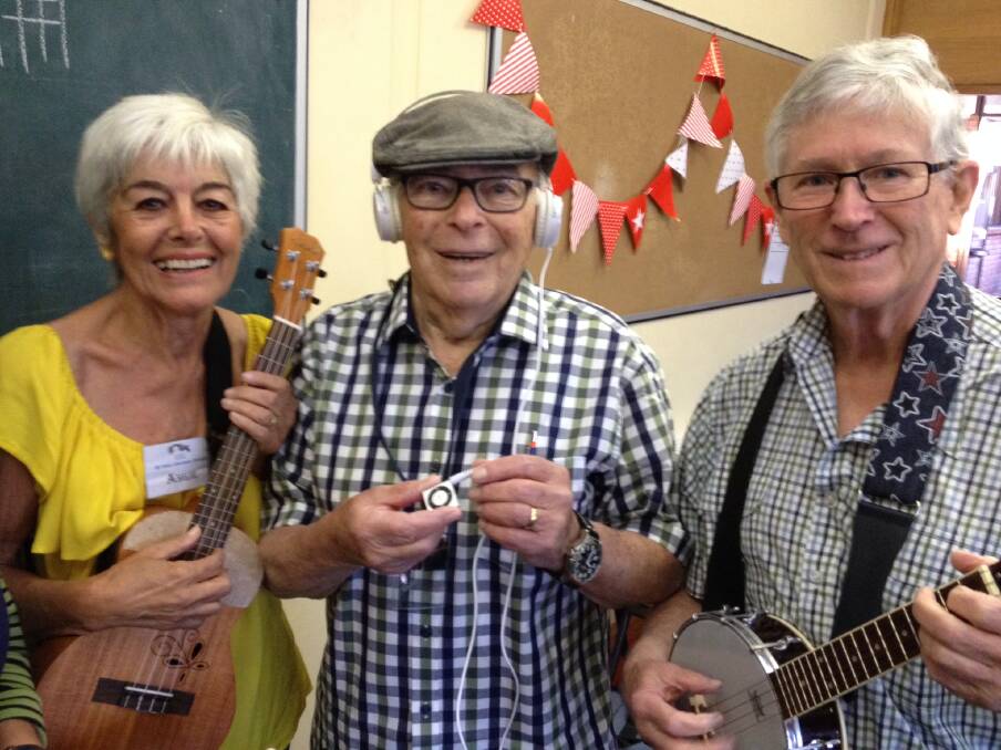 MUSIC THERAPY – From left, St Ives Ukulele Group members Angie Frank, Roscoe Behrman and Rob Ferguson with a donated iPod.