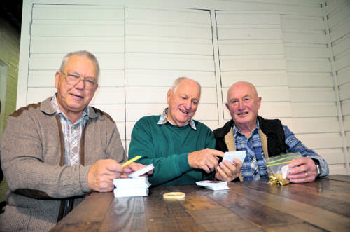 DOING THEIR BIT – Peter McGilvray (left) sets to work on the white ribbon kits with Harry Watts (centre) and Brian Chidgy; right, Peter with the finished product.