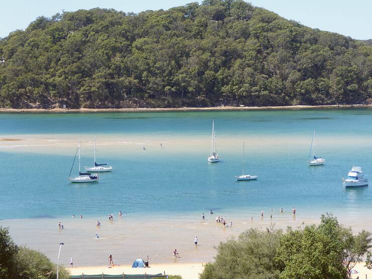 COOLING OFF – Beachgoers enjoy the sheltered waters and sand bars at Ettalong Beach.