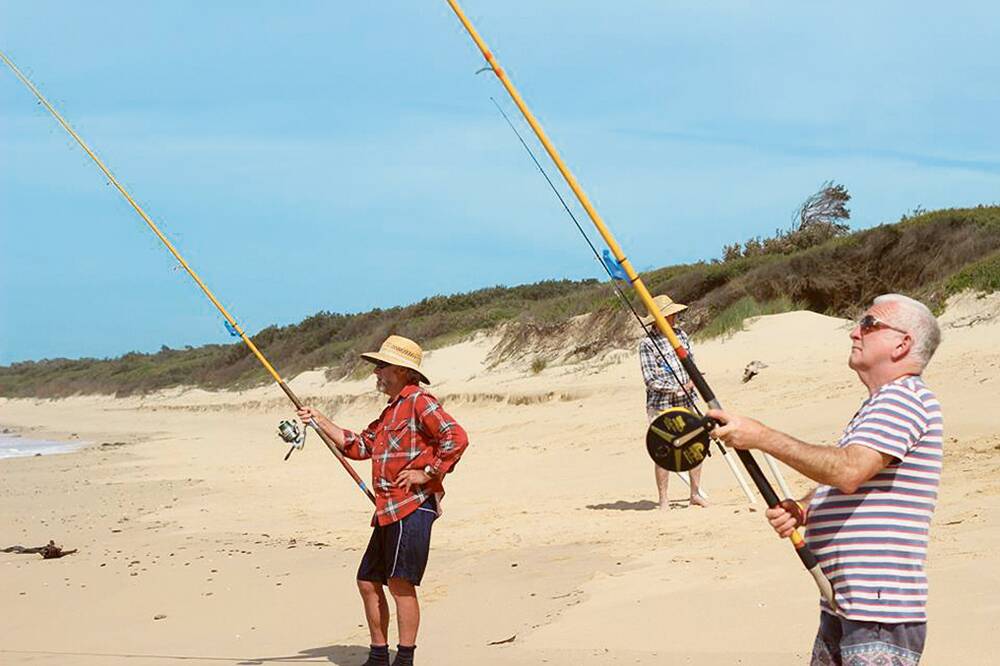 READING THE WAVES – Michael Newtown (left) and his mate get stuck into beach fishing.