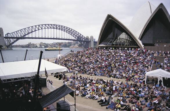 FESTIVAL SYDNEY - Crowds of people sitting on the Sydney Opera House steps watch a performance during the Sydney Festival. Photo by Jann Tuxford. Courtesy of Destination NSW .
