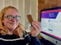 DEMOCRACY CHOCCY: Stuck at home in isolation after testing positive to COVID-19, ACM journalist Nicky Lefebvre makes do with a celebratory 'democracy TimTam' after completing her vote over the phone in the 2022 Federal Election. 