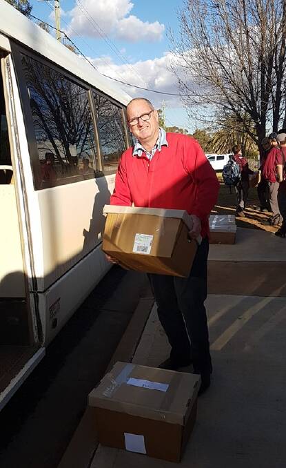 DROUGHT RELIEF: Trundle Central School principal John Southon packing the 500th hamper of food toiletries on its way home to one of the school's families on July 4. Photo: Trundle Central School Facebook page