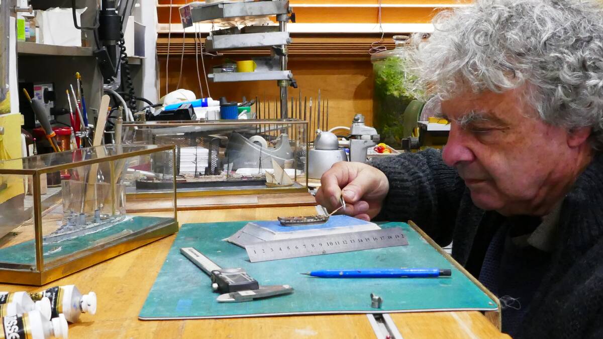 METICULOUS MINIATURIST: Model maker Michael Bennett works on a tiny replica of HMS Sirius.