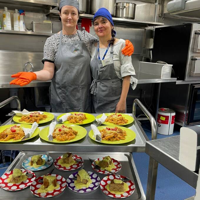 St John's volunteers (from left) Lynda Schilling and Ildiko Sander with some of the thousands of meals provided to those in need on the Gold Coast.